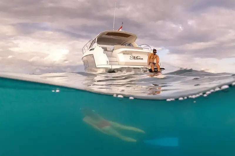 A yacht seen from the water at the reef edge