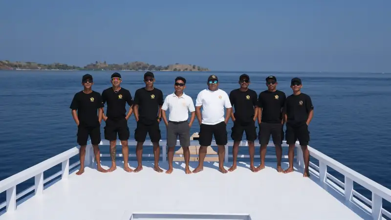 The crew lined up on the foredeck of a chartered phinisi