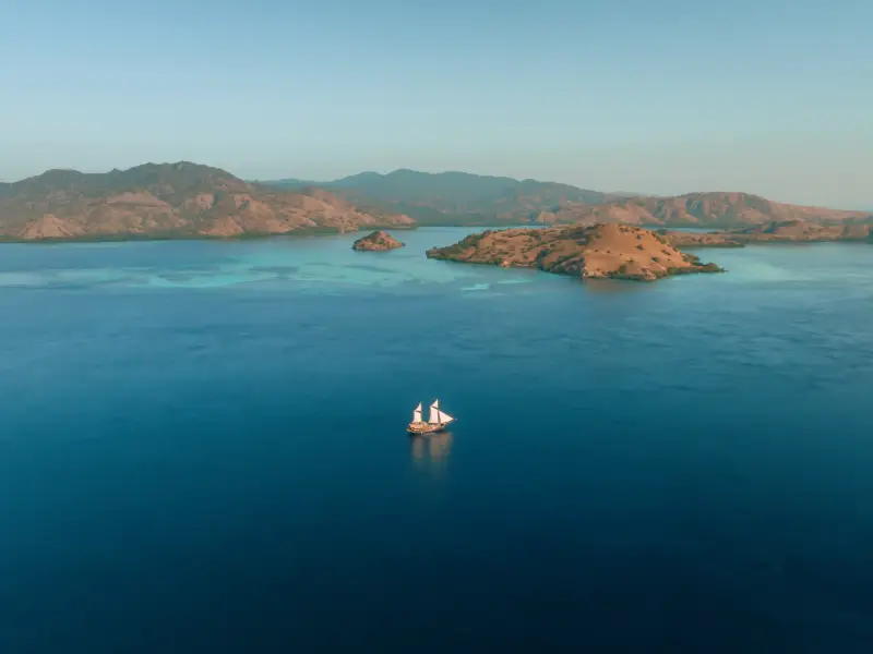 A phinisi under sail among the islands of Komodo National Park