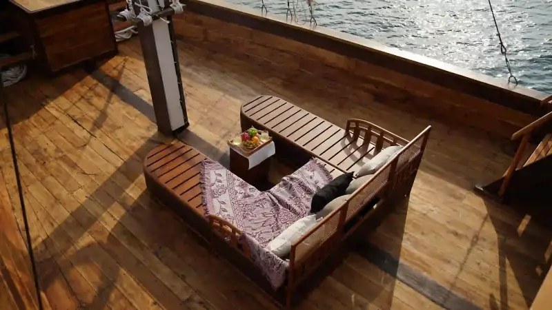 The timber deck lounge of a Superior class phinisi