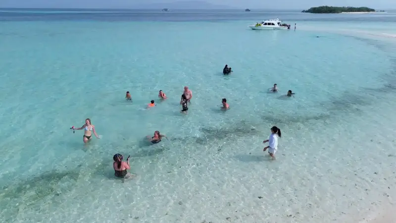 Guests in the shallows off the Taka Makassar sandbar